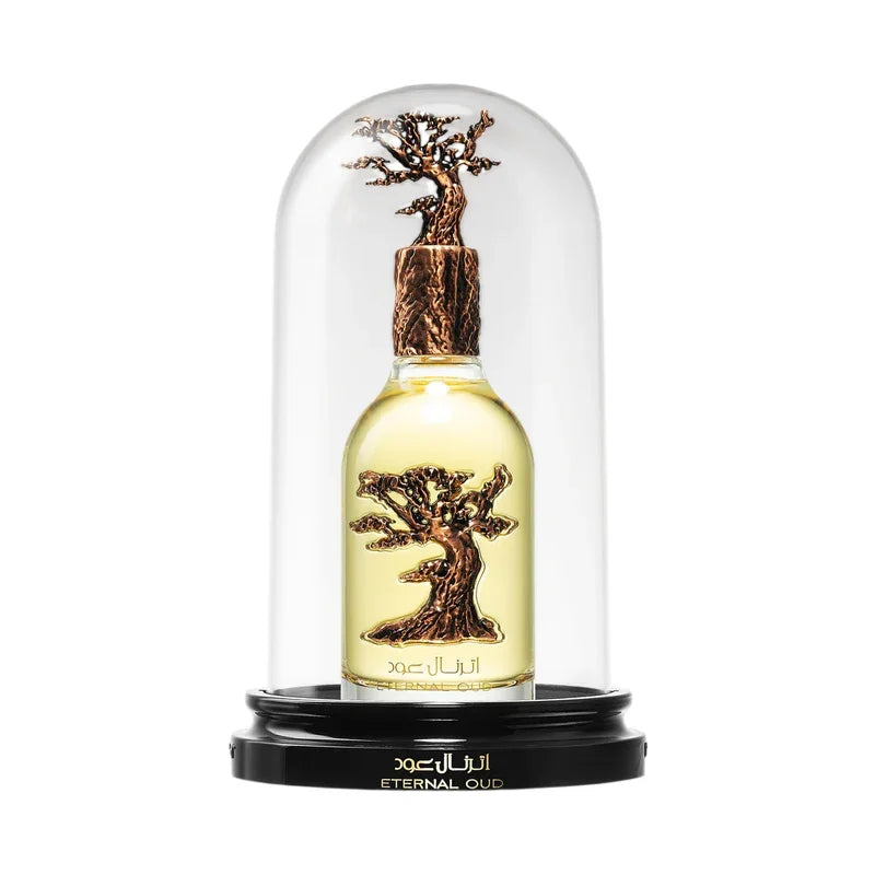 Flacon de parfum Eternal Oud sous cloche en verre avec motif d'arbre sculpté.