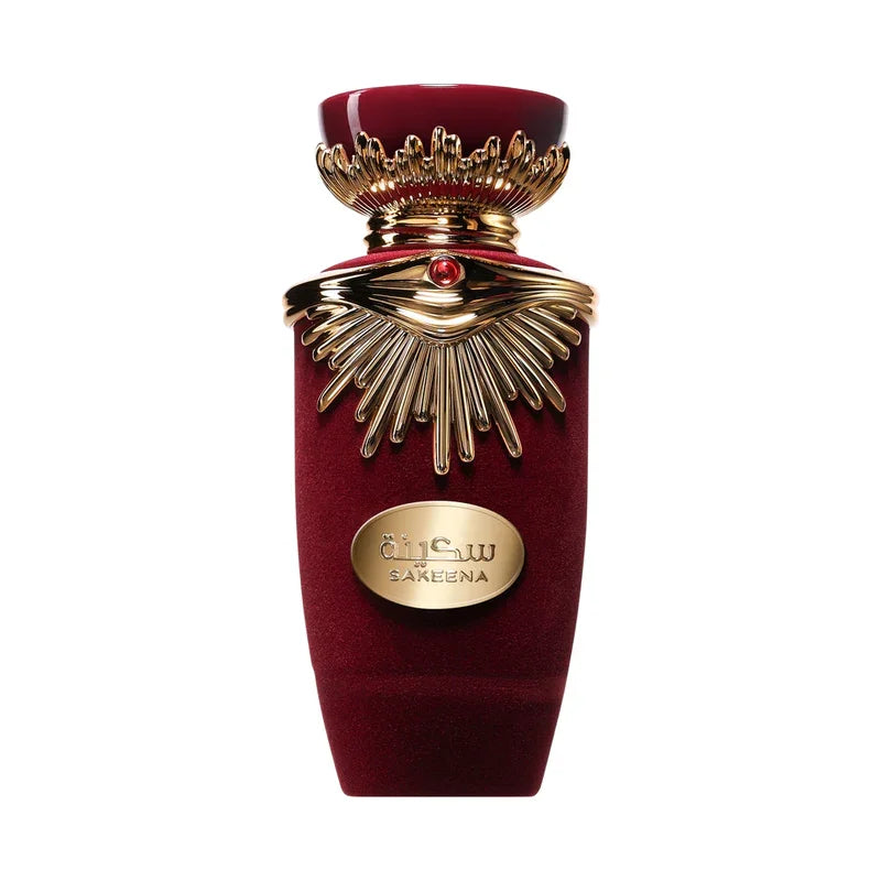 Flacon de parfum Sakeena rouge velours et or, design luxueux avec détails sculptés et pierre centrale