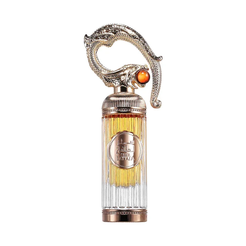 Flacon de parfum luxueux avec dragon doré et pierre orange, design élégant et détails fins